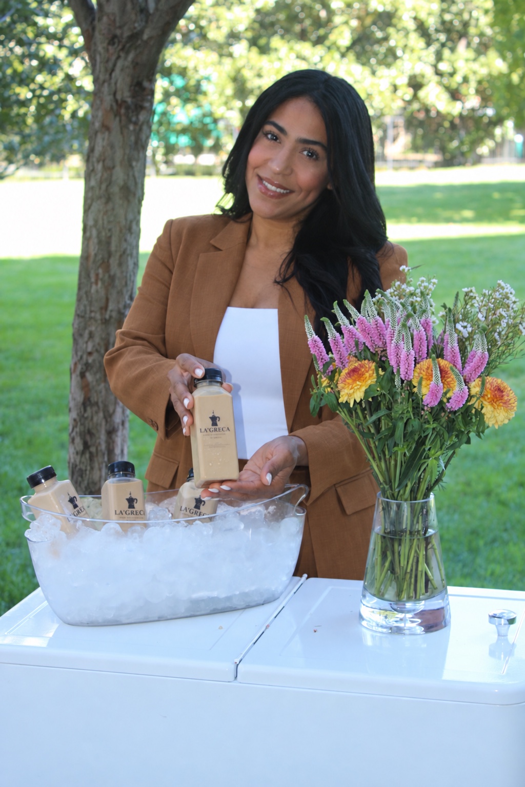 Yimelka presenting bottled La’Greca coffee over ice