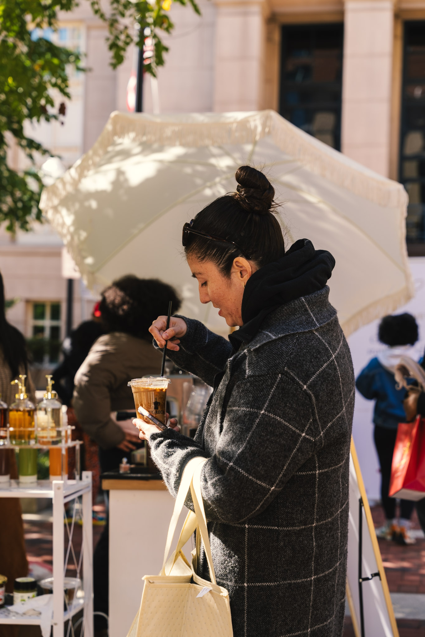 Guest in a plaid jacket holding her La’Greca coffee