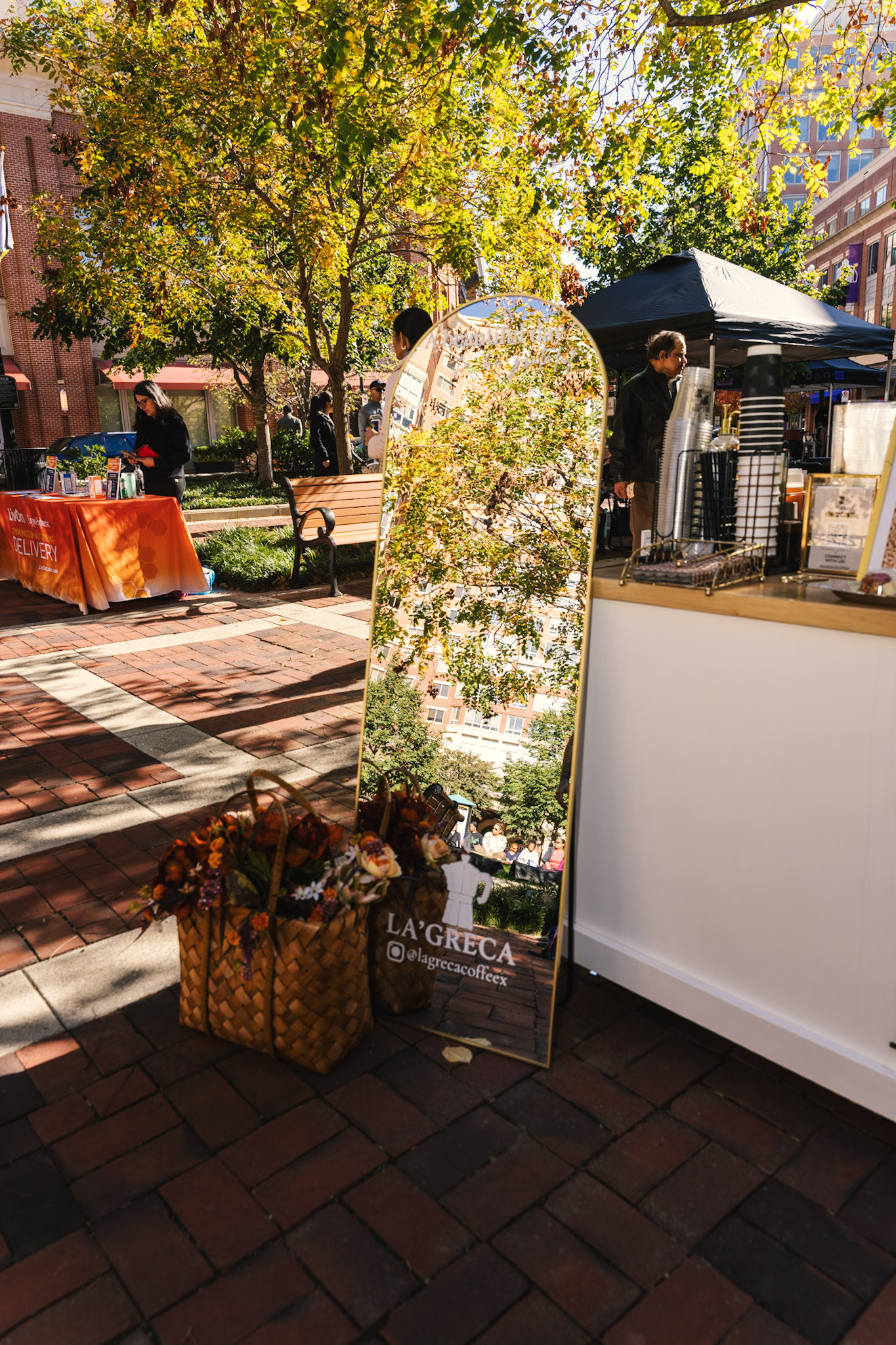 La’Greca mirror, flowers, and cart at an outdoor event