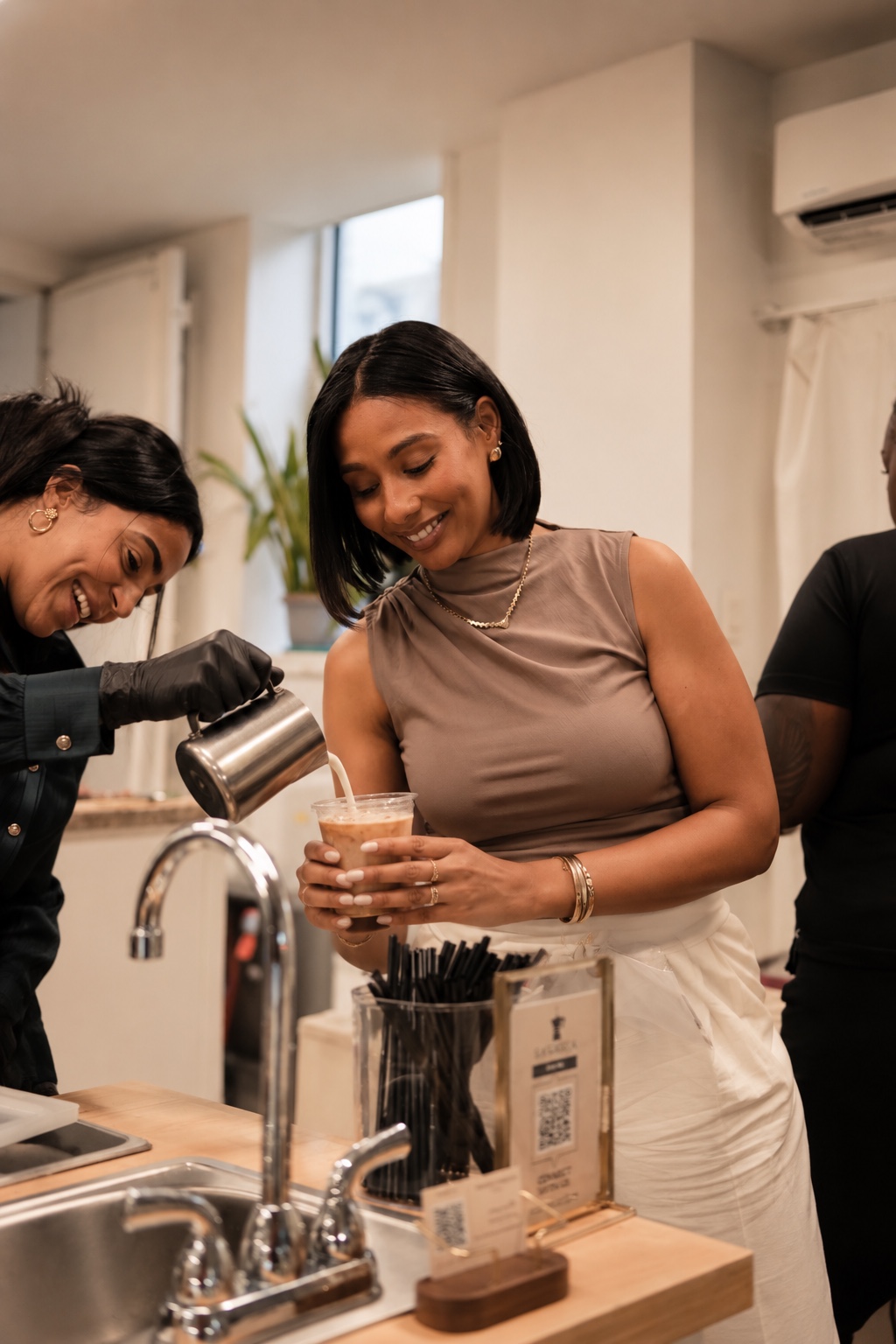 Pouring milk into a guest’s coffee