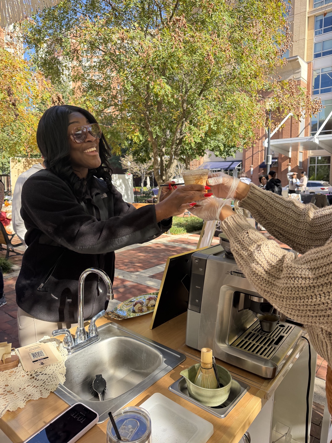 A smiling customer receiving her drink